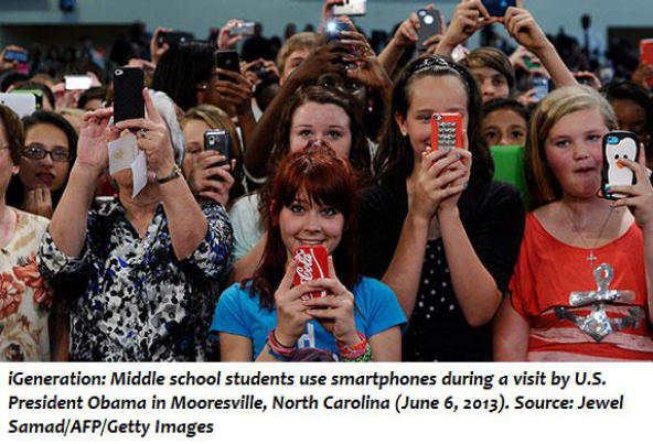 Middle school students use smartphones during a visit by U.S. President Obama in Mooresville, North Carolina (June 6, 2013). 